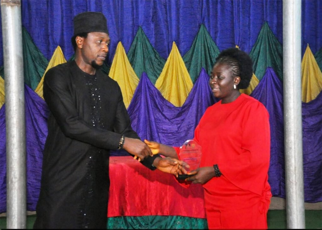 Counselor Deborah receiving an award at an event