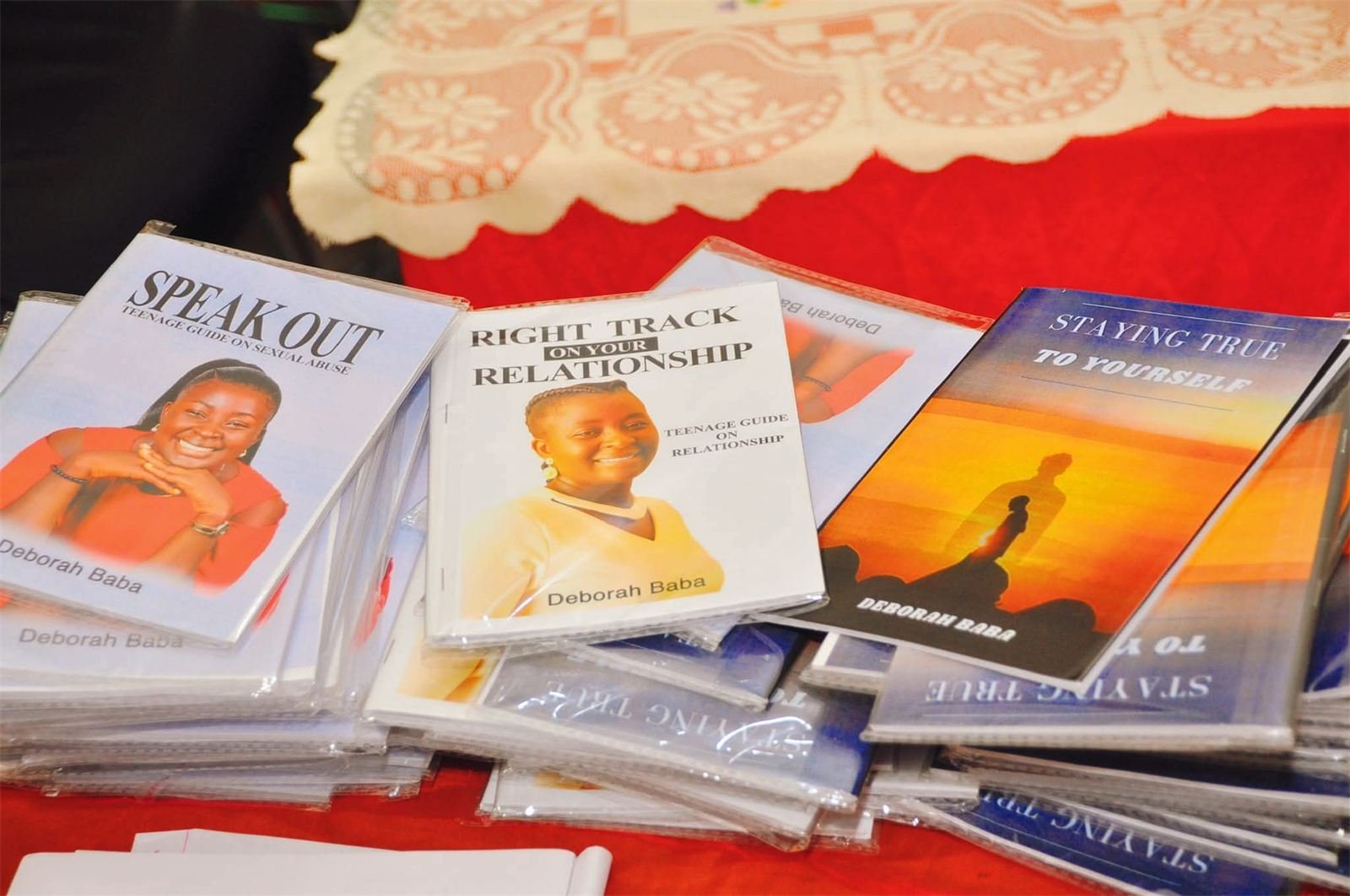 Copies of books for teenagers by Deborah Baba laid out on a table