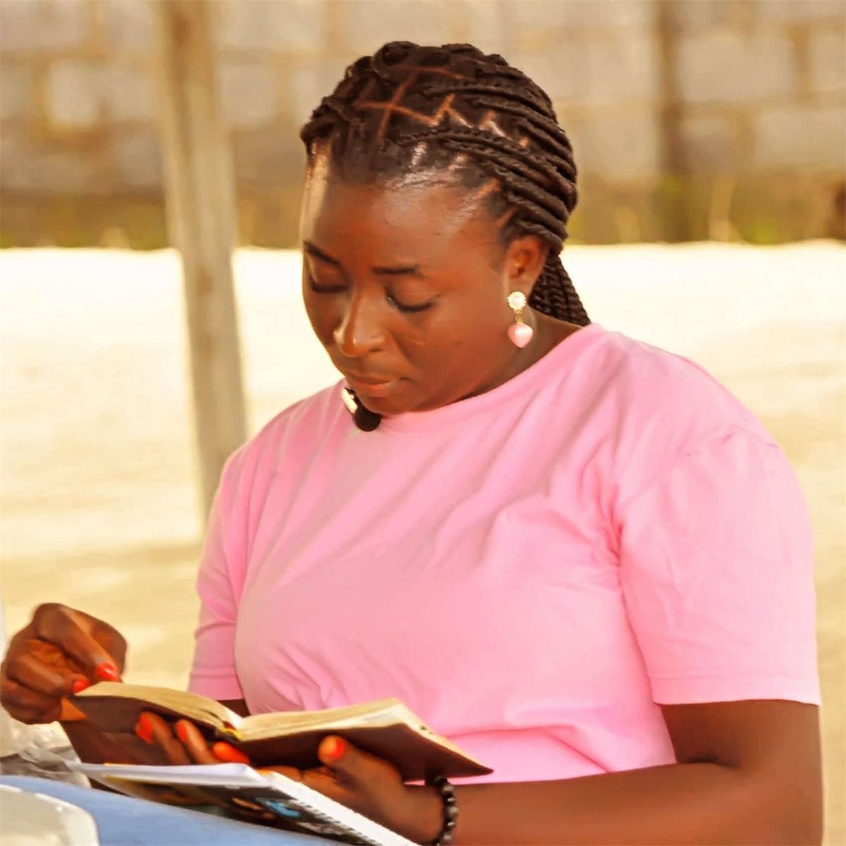 Counselor Deborah Baba reading during a quiet moment at an outreach