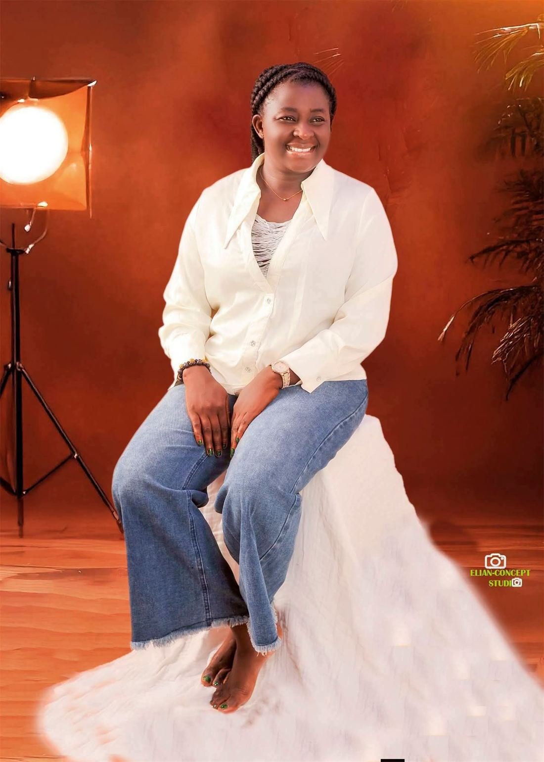 Counselor Deborah Baba seated and smiling in a studio portrait