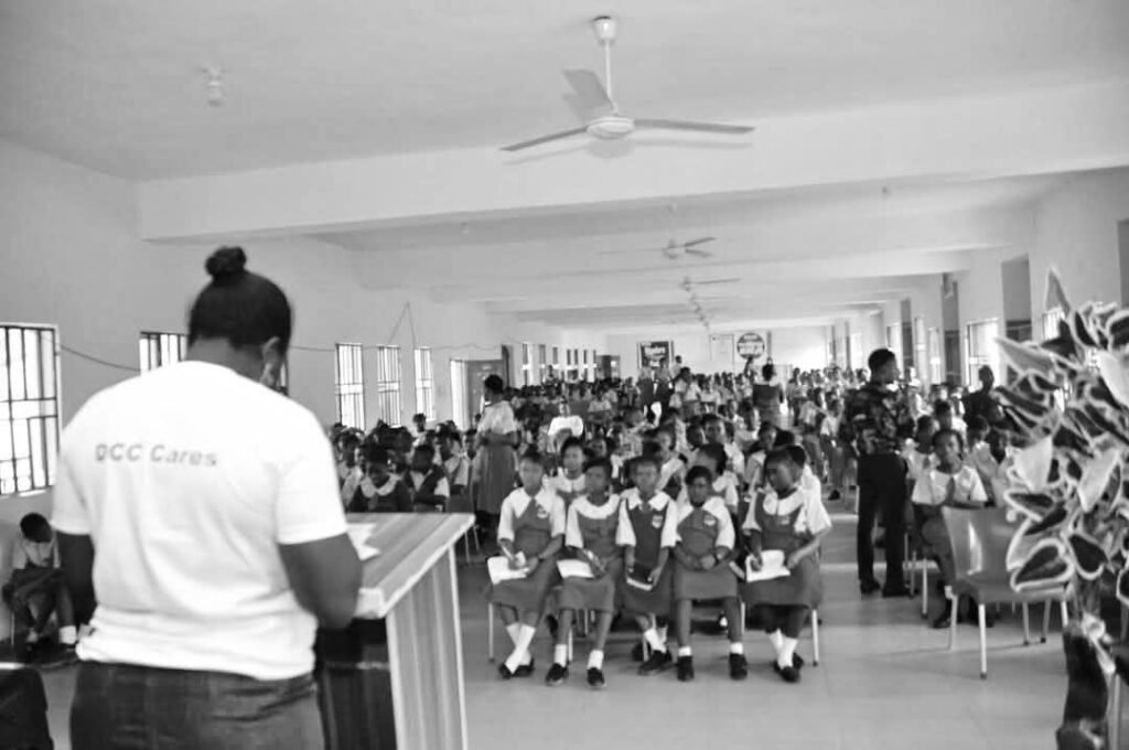 A DCC outreach session in a school hall, seen from behind the speaker