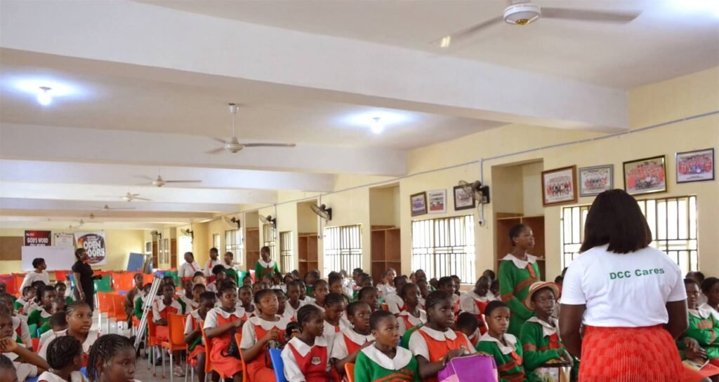 Counselor Deborah addressing a hall full of secondary school students