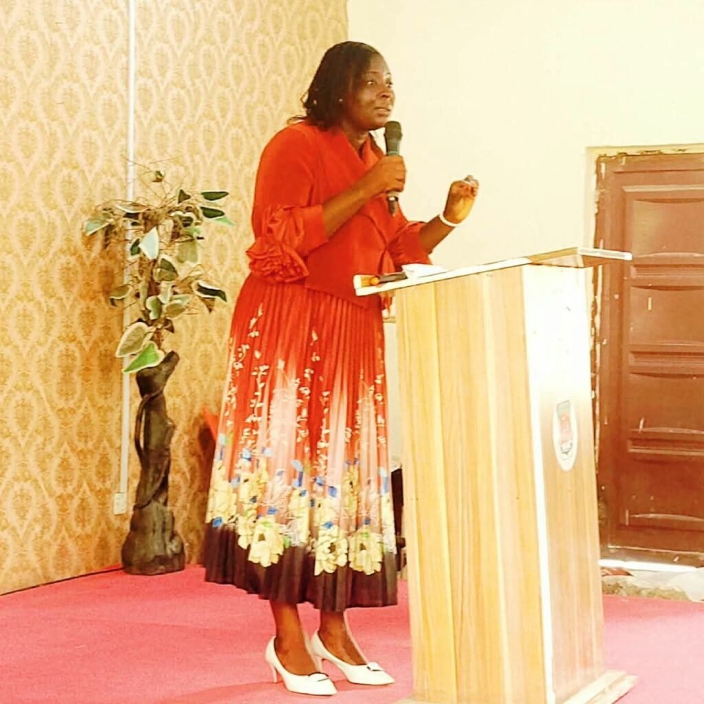 Counselor Deborah Baba speaking from a podium at an event